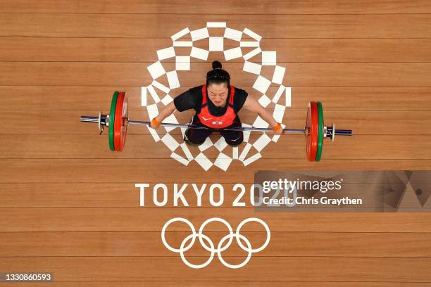 Mikiko Andoh of Team Japan competes during the Weightlifting - Women's 59kg Group A on day four of the Tokyo 2020 Olympic Games at Tokyo...