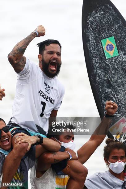 Italo Ferreira of Team Brazil shows emotion as he is chaired off the beach after winning the Gold Medal in the men’s Surfing final match against...