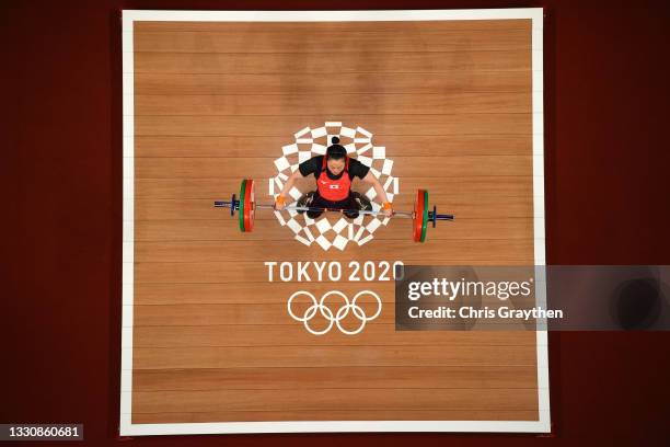 Mikiko Andoh of Team Japan competes during the Weightlifting - Women's 59kg Group A on day four of the Tokyo 2020 Olympic Games at Tokyo...