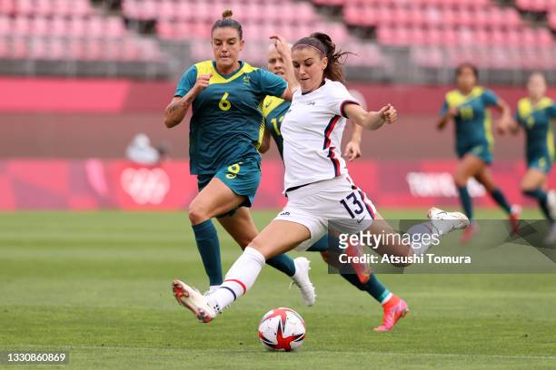 Alex Morgan of Team United States shoots whilst under pressure from Chloe Logarzo of Team Australia during the Women's Football Group G match between...