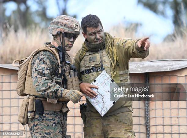 Marine from MRF-D and an Australian soldier from 'Battle Group Eagle' discuss tactics during an Urban assault as part of Exercise 'Talisman Sabre 21'...