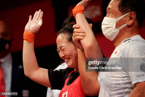 Mikiko Andoh of Team Japan competes during the Weightlifting - Women's 59kg Group A on day four of the Tokyo 2020 Olympic Games at Tokyo...