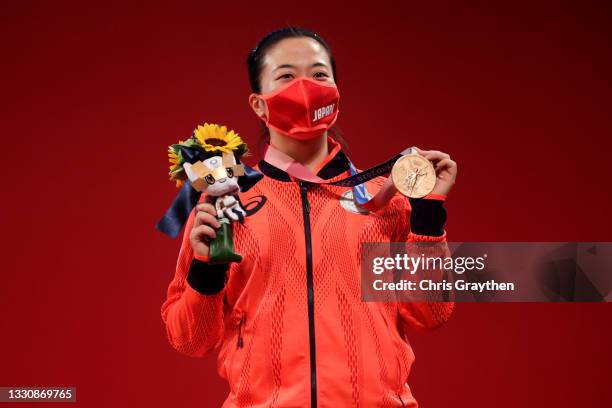 Silver medalist Mikiko Andoh of Team Japan poses with the silver medal during the medal ceremony for the Weightlifting - Women's 59kg Group Aon day...