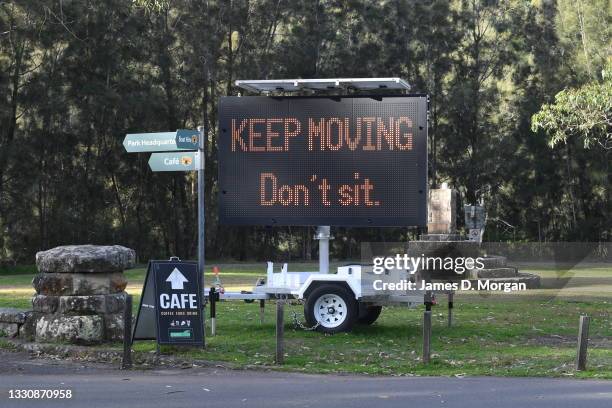 Digital Covid-19 warning signs in the Lane Cove National Park on July 27, 2021 in Sydney, Australia. New South Wales continues to record new...