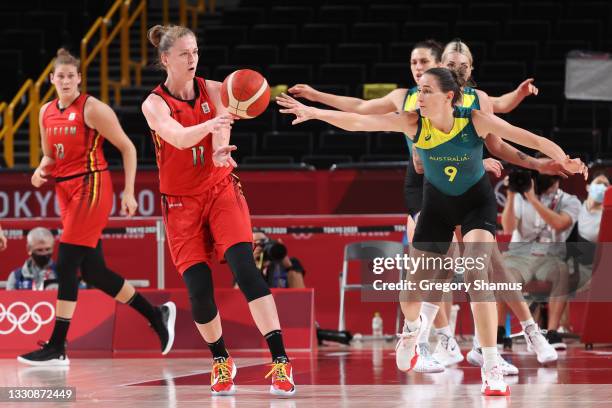 Emma Meesseman of Team Belgium passes the ball as she is pressured by Bec Allen of Team Australia during the first half of a Women's Preliminary...