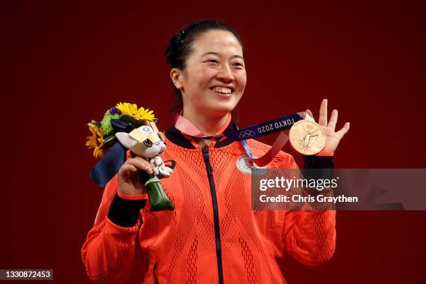 Silver medalist Mikiko Andoh of Team Japan poses with the silver medal during the medal ceremony for the Weightlifting - Women's 59kg Group Aon day...