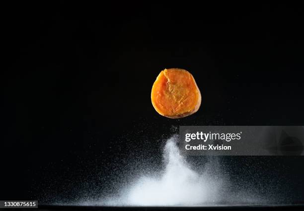 prepared sweet potato flying in mid air captured with high speed sync. - kartoffelblüte nahaufnahme stock-fotos und bilder