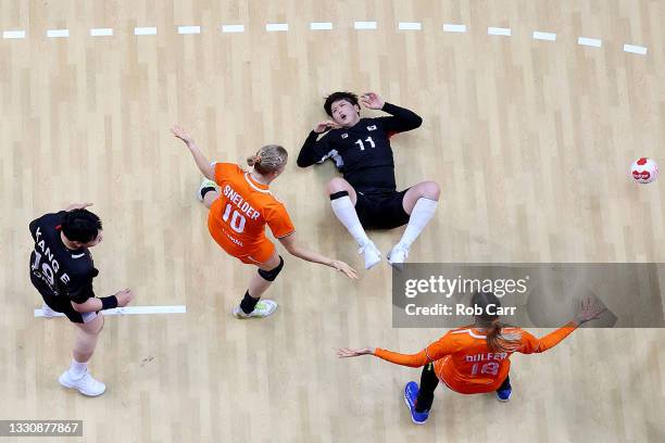 Ryu Eun Hee of Team South Korea falls to the ground after being challenged by Danick Snelder of Team Netherlands as Kelly Dulfer of Team Netherlands...