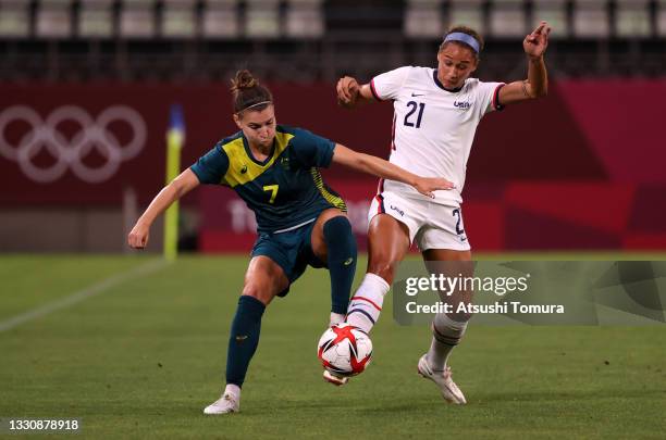 Steph Catley of Team Australia battles for possession with Lynn Williams of Team United States during the Women's Football Group G match between...