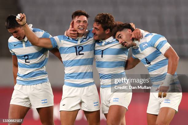 Lucio Cinti, Marcos Moneta, Rodrigo Isgro and Ignacio Mendy celebrate after their victory during the Rugby Sevens Men's Quarter-final match between...