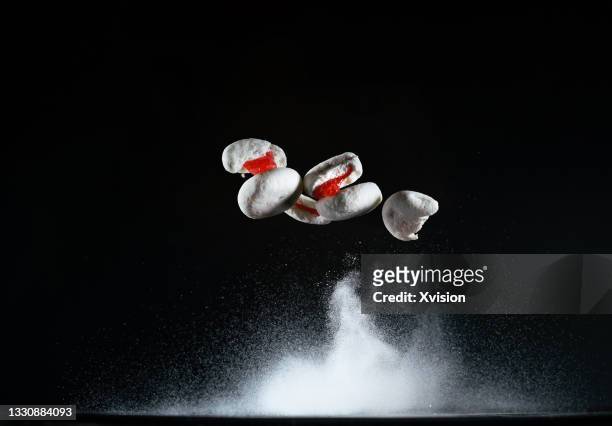 marshmallow with red jelly filling flying in mid air captured with high speed"n - gelatin powder fotografías e imágenes de stock