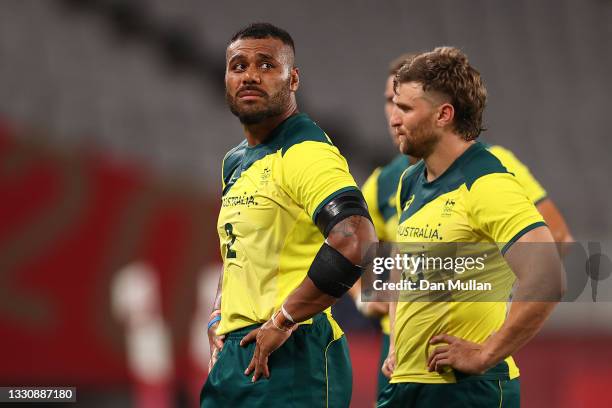 Samu Kerevi and Lewis Holland of Team Australia look dejected after their defeat during the Rugby Sevens Men's Quarter-final match between Australia...