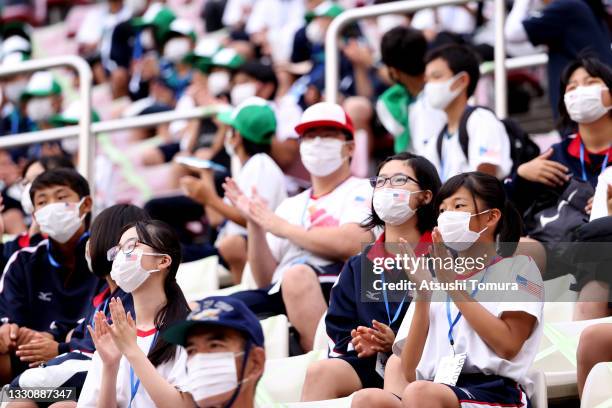 Fans wearing face masks applaud during the Women's Football Group G match between United States and Australia on day four of the Tokyo 2020 Olympic...