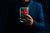 Transparency smart phone with ransomware attack warning sign.