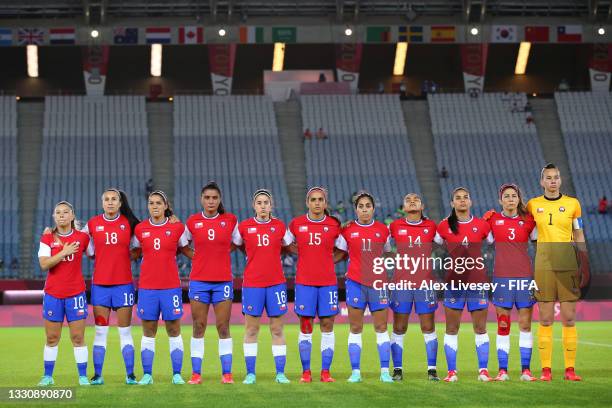 Players of Team Chile stand for the national anthem prior to the Women's Group E match between Chile and Japan on day four of the Tokyo 2020 Olympic...