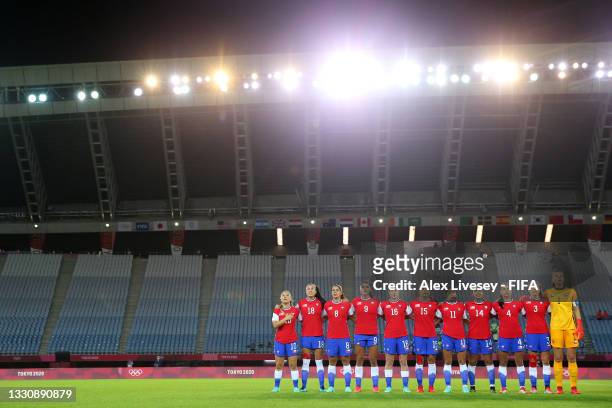 Players of Team Chile stand for the national anthem prior to the Women's Group E match between Chile and Japan on day four of the Tokyo 2020 Olympic...