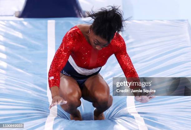 Simone Biles of Team United States stumbles upon landing after competing in vault during the Women's Team Final on day four of the Tokyo 2020 Olympic...