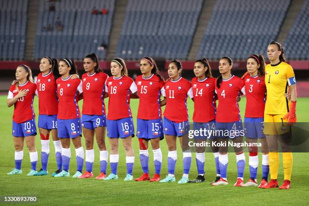 Players of Team Chile stand for the national anthem prior to the Women's Group E match between Chile and Japan on day four of the Tokyo 2020 Olympic...