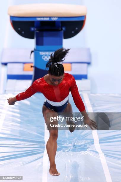 Simone Biles of Team United States stumbles upon landing after competing in vault during the Women's Team Final on day four of the Tokyo 2020 Olympic...