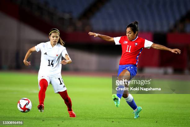 Yui Hasegawa of Team Japan runs with the ball whilst under pressure from Yessenia Lopez of Team Chile during the Women's Group E match between Chile...