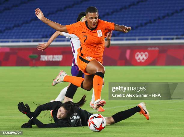 Shanice van de Sanden of Team Netherlands goes round Shimeng Peng of Team China to score their side's first goal during the Women's Group F match...