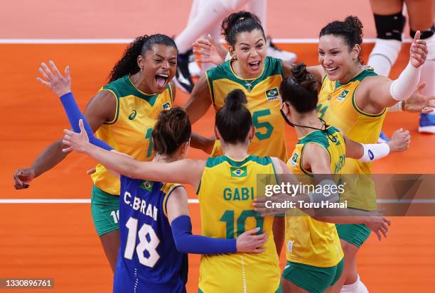 Fernanda Rodrigues and Ana Carolina da Silva of Team Brazil react with team mates against Team Dominican Republic during the Women's Preliminary -...