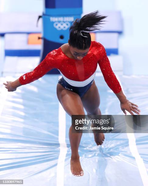 Simone Biles of Team United States stumbles upon landing after competing in vault during the Women's Team Final on day four of the Tokyo 2020 Olympic...