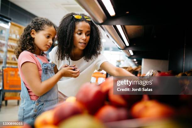 mother and her daughter shopping in a supermarket - barcelona shopping stock pictures, royalty-free photos & images