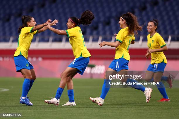 Andressa of Team Brazil celebrates with team mates after scoring their side's first goal during the Women's Group F match between Brazil and Zambia...