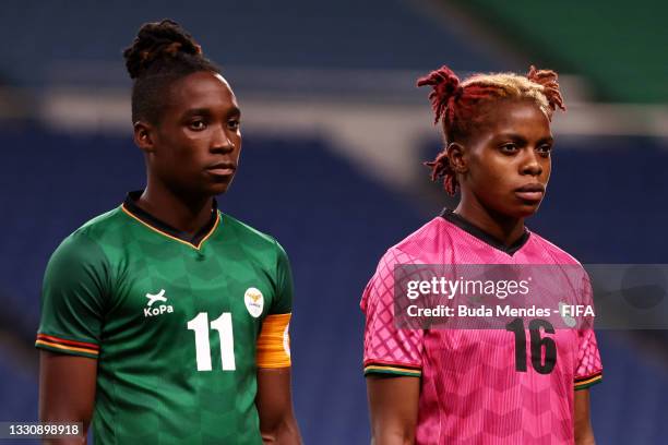 Babra Banda and Hazel Nali of Team Zambia look on during the national anthem prior to the Women's Group F match between Brazil and Zambia on day four...