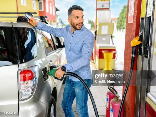 man refuel the car - garage stock pictures, royalty-free photos & images