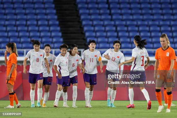 Shanshan Wang of Team China celebrates with teammates Yan Wang, Shuang Wang, Xin Zhang and Lina Yang after scoring their side's first goal during the...