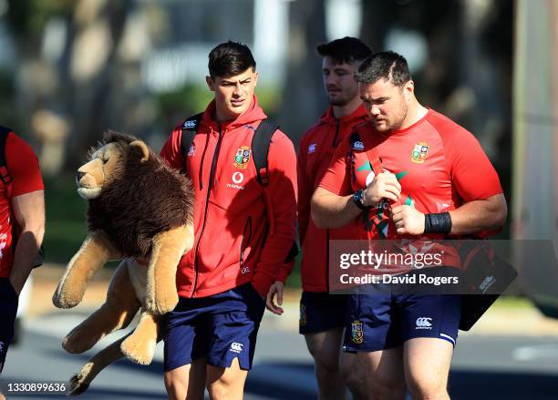 Louis Rees-Zammit, carries the Lions mascot BIL as the team arrive for the British & Irish Lions training session held at Hermanus High School on...