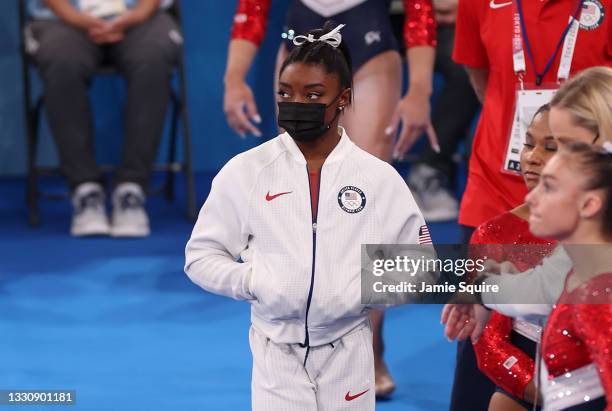 Simone Biles of Team United States looks on during the Women's Team Final on day four of the Tokyo 2020 Olympic Games at Ariake Gymnastics Centre on...