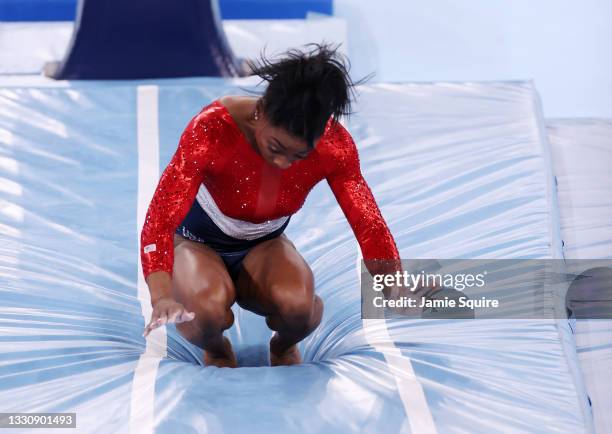 Simone Biles of Team United States stumbles upon landing after competing in vault during the Women's Team Final on day four of the Tokyo 2020 Olympic...