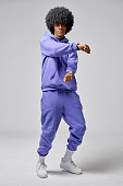 Young black man in set of purple tracksuit