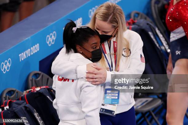 Simone Biles of Team United States is embraced by coach Cecile Landi during the Women's Team Final on day four of the Tokyo 2020 Olympic Games at...