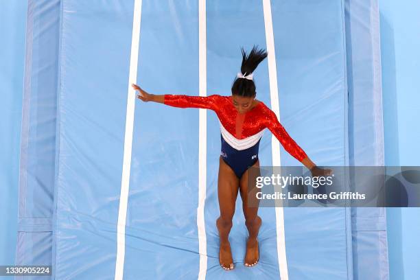 Simone Biles of Team United States stumbles upon landing after competing in vault during the Women's Team Final on day four of the Tokyo 2020 Olympic...