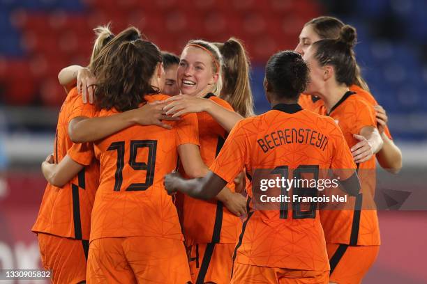 Lieke Martens of Team Netherlands celebrates with Jackie Groenen and teammates after scoring their side's fourth goal during the Women's Group F...