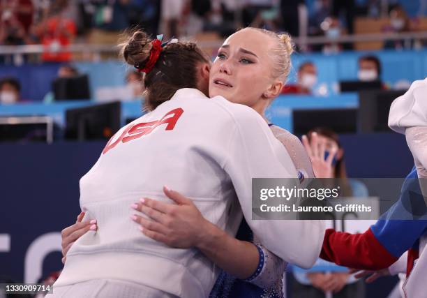 Simone Biles of Team United States congratulates Angelina Melnikova of Team ROC after Team ROC's gold medal win during the Women's Team Final on day...