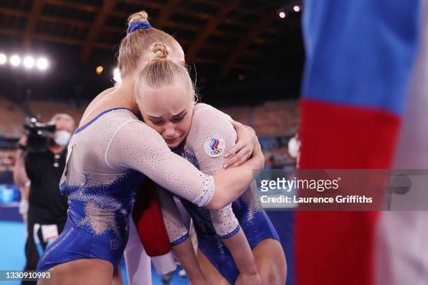 Angelina Melnikova of Team ROC reacts is embraced by Liliia Akhaimova of Team ROC after competing in floor exercise during the Women's Team Final on...