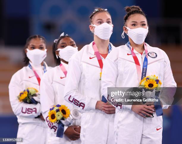Jordan Chiles, Simone Biles, Grace McCallum and Sunisa Lee of Team United States react on the podium after winning the silver medal during the...