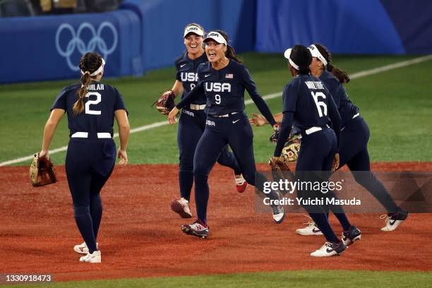 Janette Reed of Team United States celebrates with teammates after making a catch at the wall in the seventh inning against Team Japan during the...