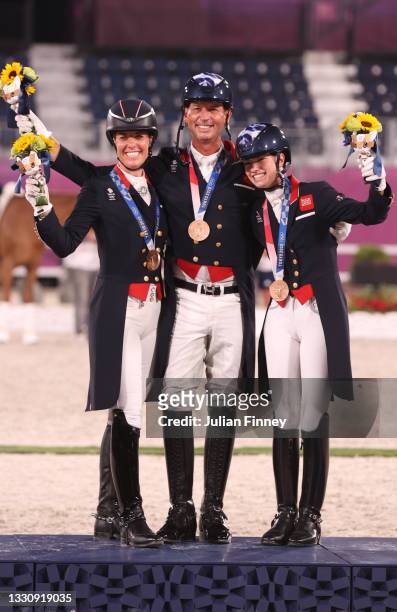Bronze medalist Charlotte Dujardin, Carl Hester and Charlotte Fry of Team Great Britain pose on the podium during the medal ceremony for the Dressage...