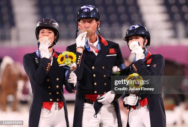 Bronze medalist Charlotte Dujardin, Carl Hester and Charlotte Fry of Team Great Britain pose on the podium during the medal ceremony for the Dressage...