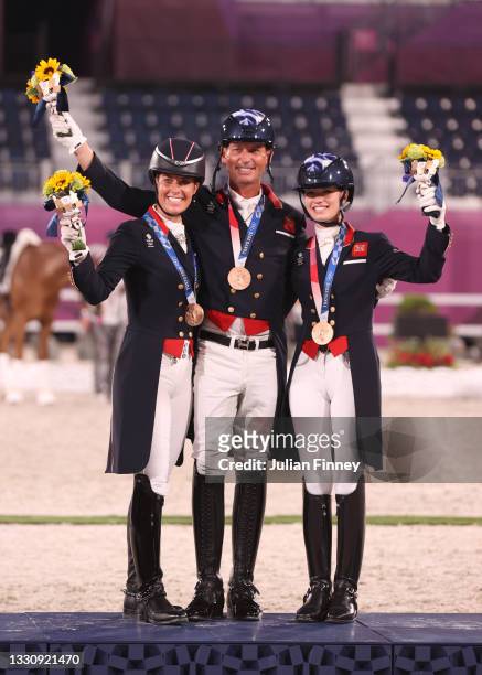 Bronze medalist Charlotte Dujardin, Carl Hester and Charlotte Fry of Team Great Britain pose on the podium during the medal ceremony for the Dressage...