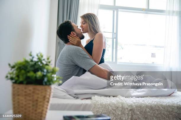 nothing enriches life like love - couple on bed stock-fotos und bilder