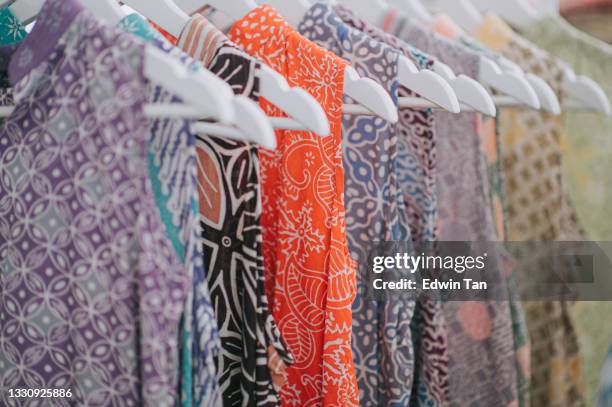 a row of sleeveless shirt printed batik with hand painted malaysia textile culture - batik 個照片及圖片檔