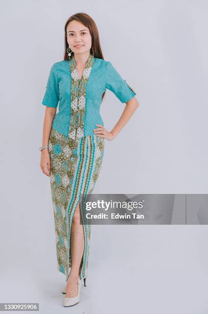 studio portrait malaysian chinese beautiful woman with batik dress malay tradition clothing with white background looking at camera smiling - batik dress stock pictures, royalty-free photos & images