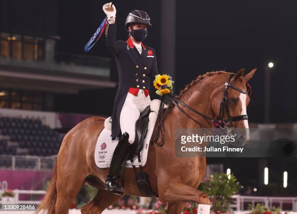Bronze medalist Charlotte Dujardin riding Gio celebrates after the medal ceremony for the Dressage Team Grand Prix Special Team Final on day four of...
